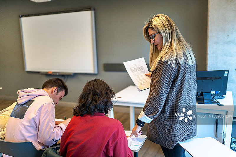 女教授帮助大学生讲课图片素材
