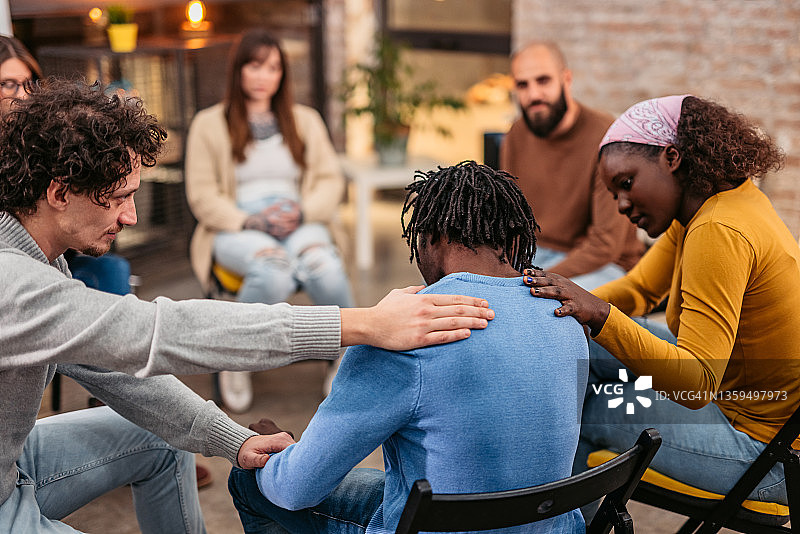 团体治疗成员正在安慰会议的另一位成员图片素材