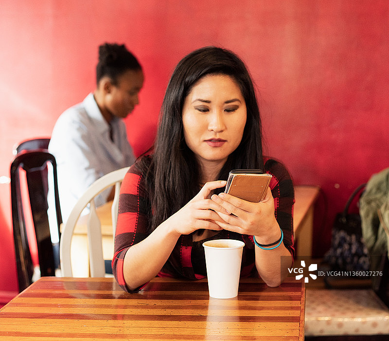 一边喝咖啡一边查看手机消息图片素材