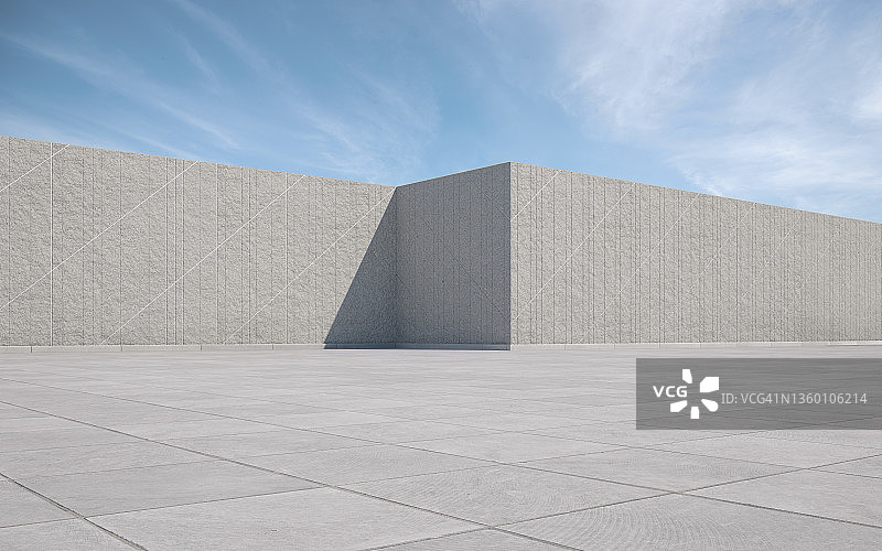 空旷的方形地面与蓝色天空下的石墙图片素材