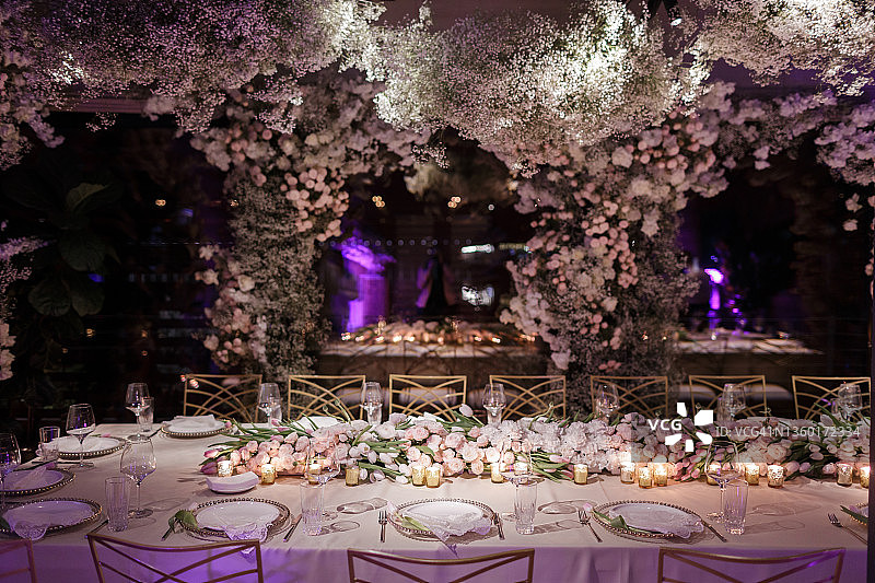 优雅节日餐桌上方的繁茂花卉装饰图片素材