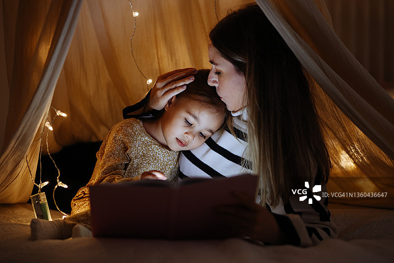 睡前，母子在床上一起读书图片素材