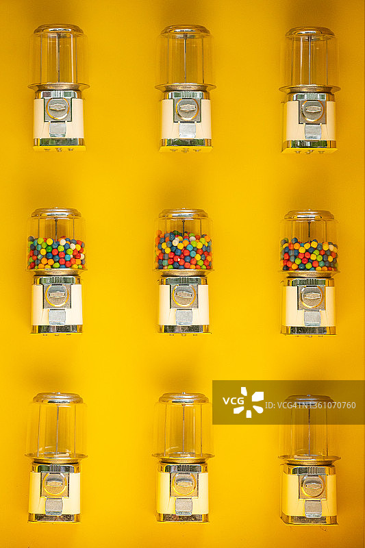 黄色墙面上的泡泡糖自动售货机图片素材