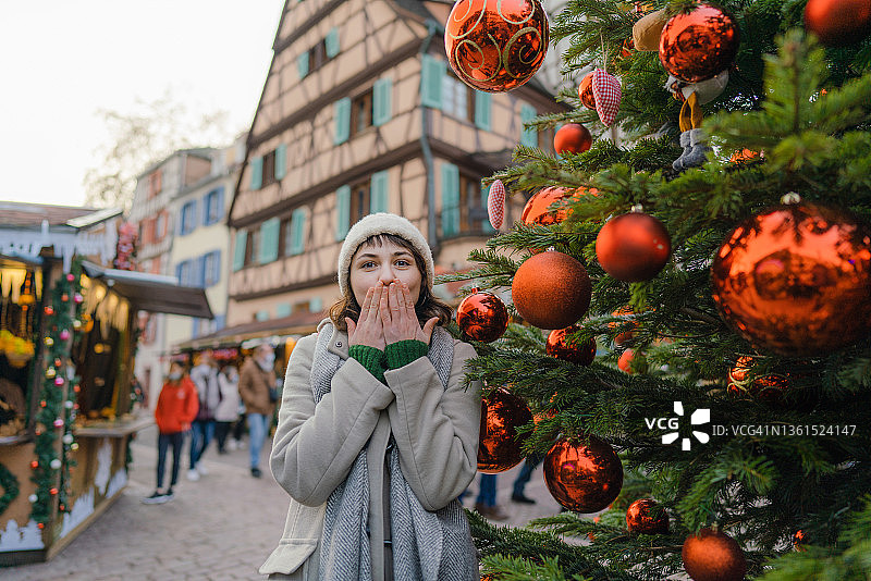 在圣诞树旁飞吻的女人图片素材