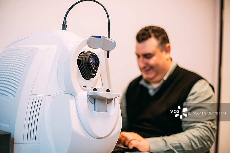 技术员使用眼科光学相干断层扫描设备图片素材