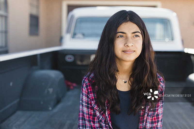坐在皮卡车后部的少女图片素材