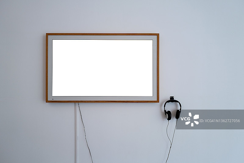 白色墙壁上的设备屏幕和耳机图片素材