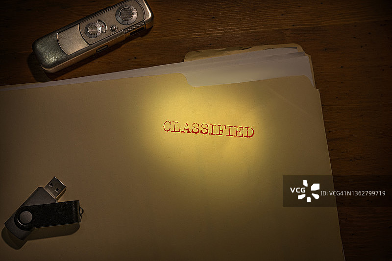 标记为机密的文件夹，带间谍相机和拇指驱动器图片素材