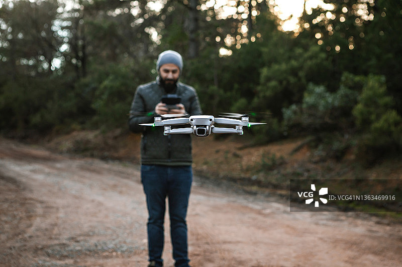 男人用遥控器操控无人机图片素材