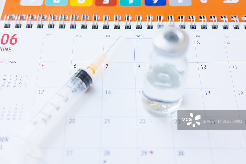 日历上的注射器和疫苗图片素材