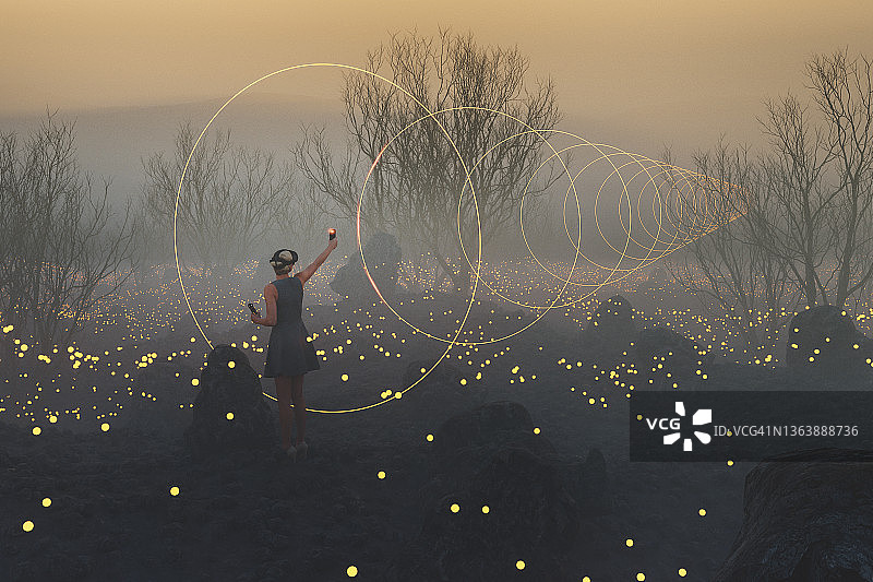 年轻女人在VR环境中创建奇幻景观图片素材