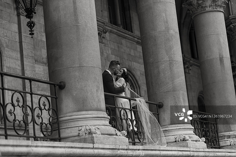 巨大柱子附近接吻的美丽新人图片素材