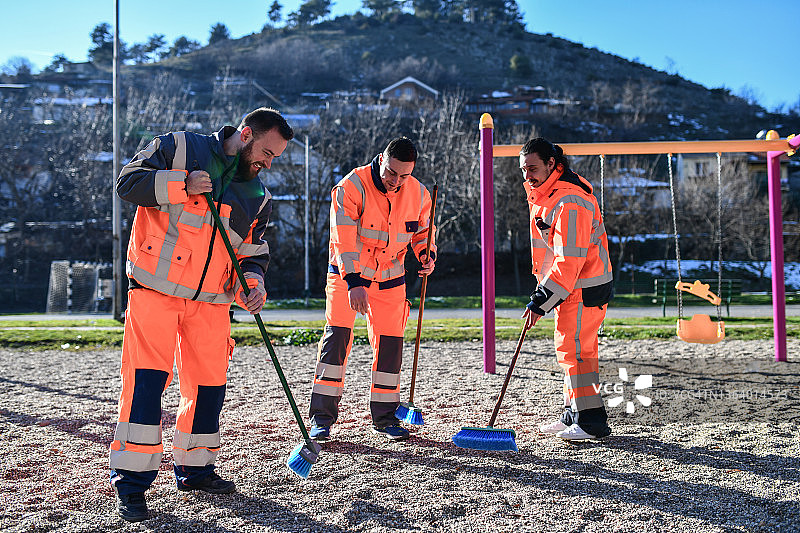 保持游乐场沙滩清洁的男性环卫工人图片素材