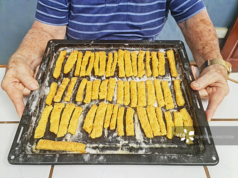 自豪的老年人展示亲手烘焙的面包图片素材