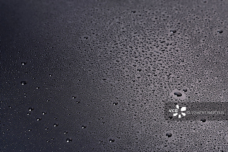 深黑色背景上的水滴或美容化妆品面部精华液、精油图片素材