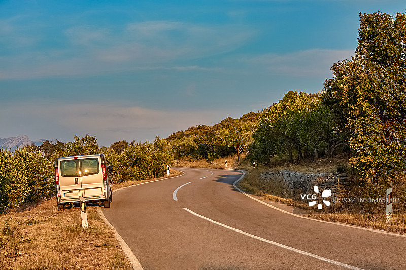 日落时分停在橄榄园路边的厢型车图片素材
