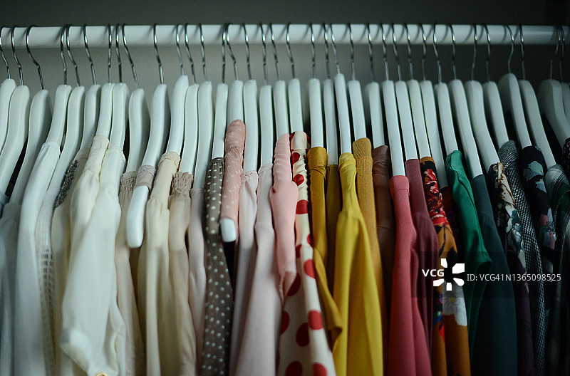 按颜色排列的针织毛衣和女式衬衫图片素材