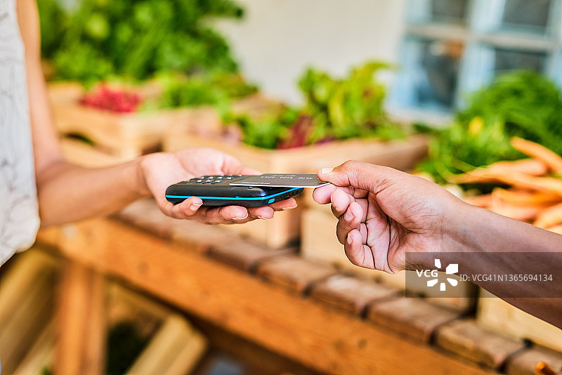 顾客在商店用信用卡付款的特写镜头图片素材