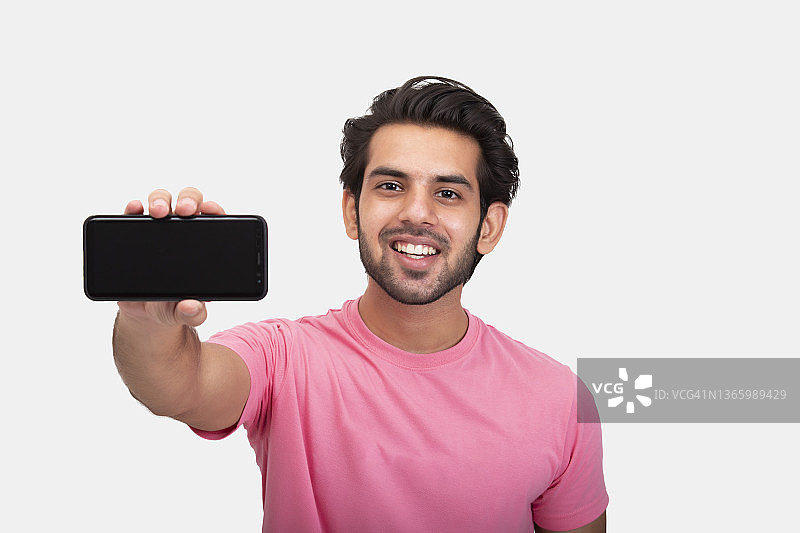 年轻男人展示手机空白屏幕图片素材
