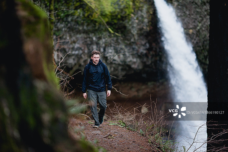 在俄勒冈州森林小路上行走的男徒步旅行者图片素材