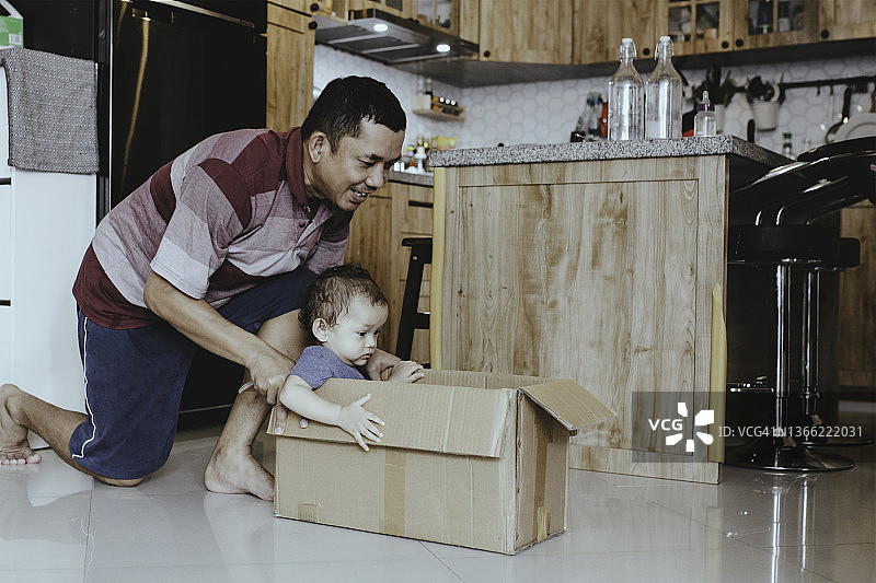 父亲用纸板箱当汽车玩具图片素材