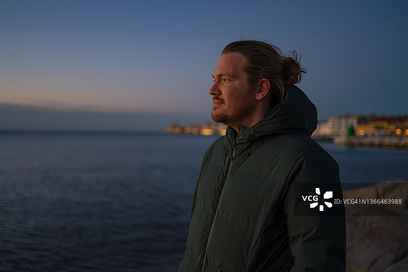 青年在日出时于海边放松图片素材