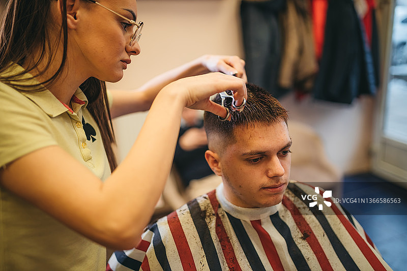 年轻男人在理发店理发图片素材