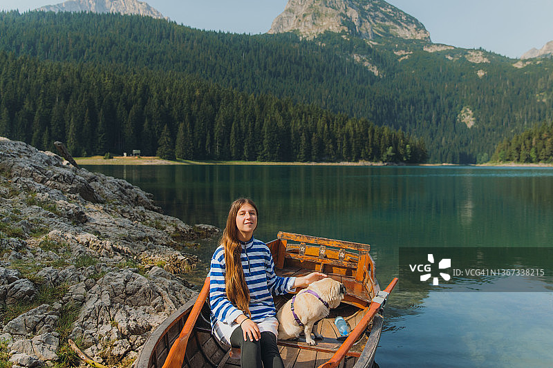 在黑湖乘船欣赏山景的女人图片素材