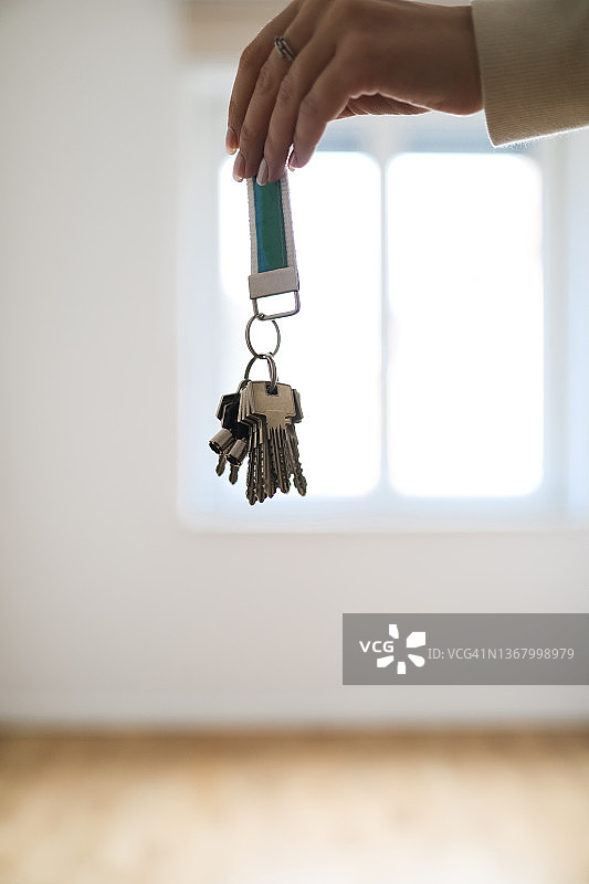 在新空房里拿着钥匙的女人图片素材