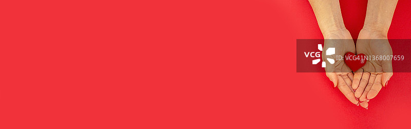 情人节，红底上的心中的手图片素材