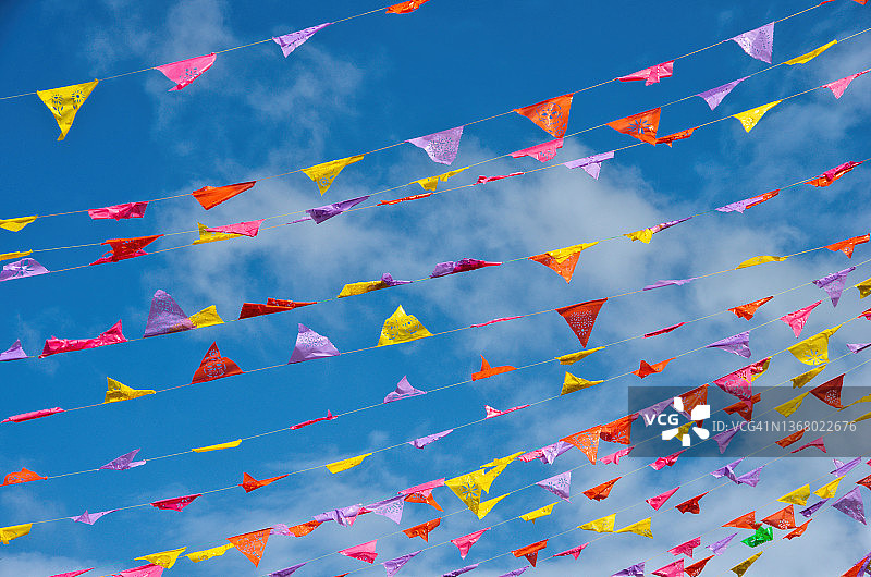 五彩纸旗在阳光明媚的天空下迎风飘扬图片素材