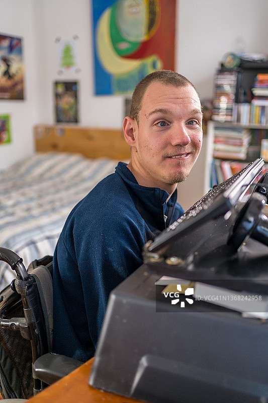 一个残疾男子用鼻子在电脑键盘上写作图片素材