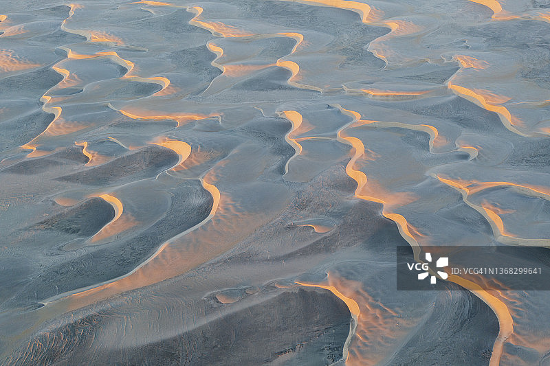 日出时分的抛物线形沙丘鸟瞰图图片素材