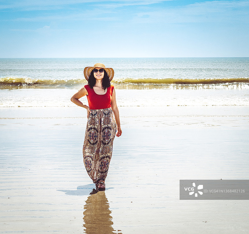 在田园诗般的海滩上，一位时尚的非洲-加勒比海人图片素材