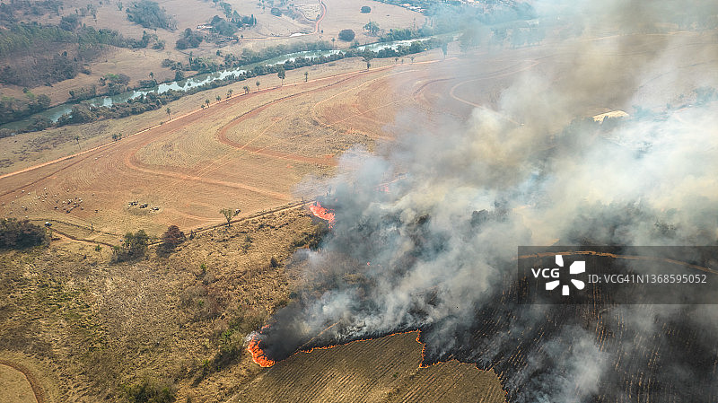 火灾中燃烧的土地上升起的烟雾图片素材