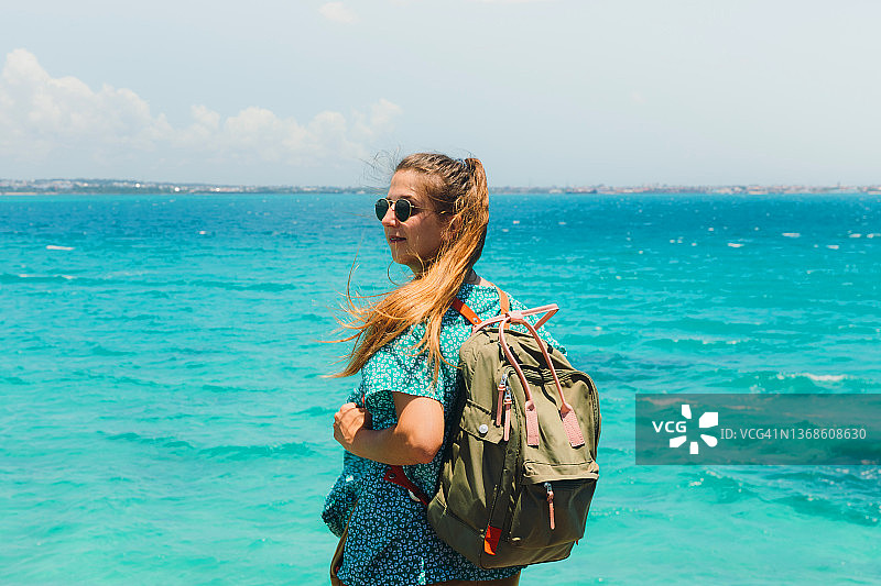 背包女旅行者探索桑给巴尔热带岛屿美景图片素材