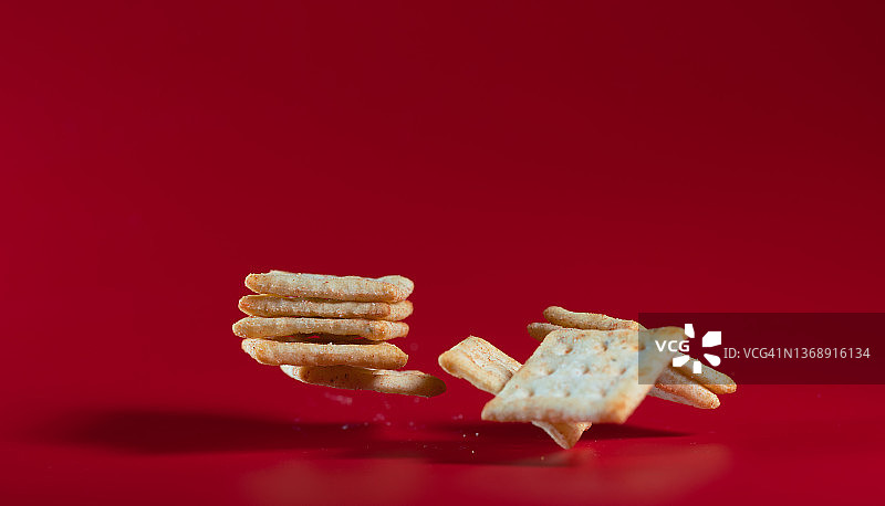 红色背景中飞舞的苏打饼干图片素材
