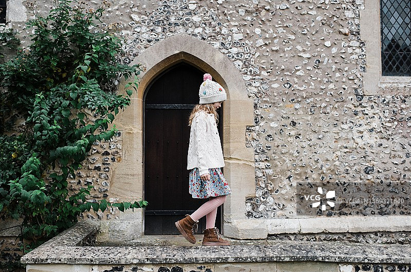 在温彻斯特古老的英国石墙上行走的女孩图片素材