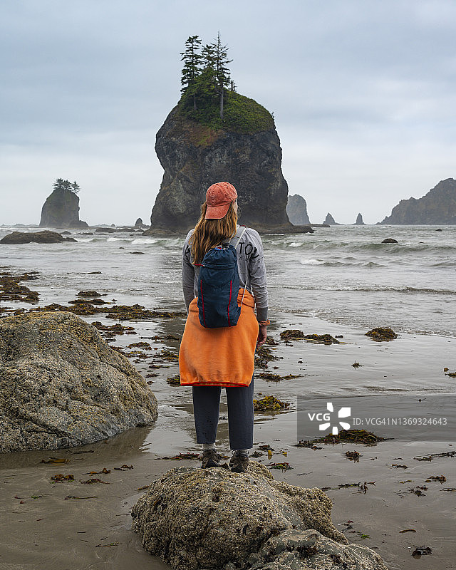 在退潮时奥林匹克海岸的 সমুদ্র堆旁摆姿势的女人图片素材