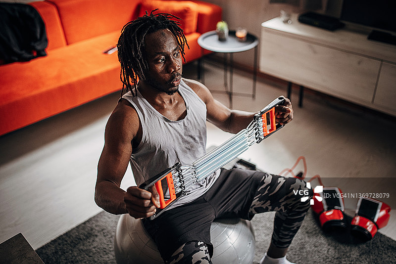 用拉力器锻炼的男人图片素材