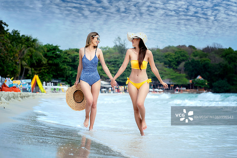 年轻女子身穿比基尼在热带海滩上图片素材