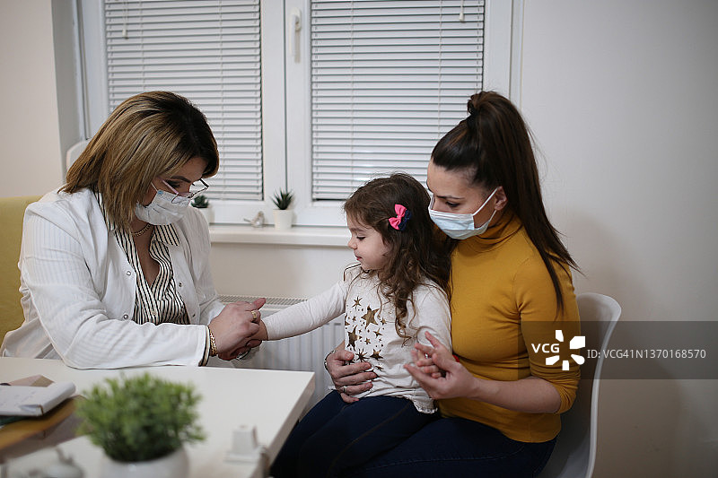 皮肤科医生为小女孩进行体检照片图片素材