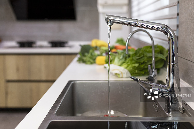 不锈钢厨房水槽、水龙头和蔬菜图片素材