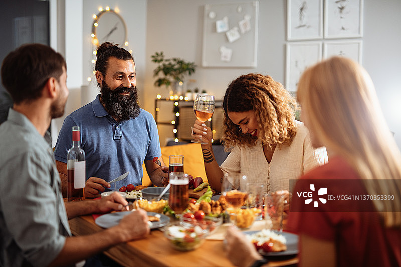 朋友和家人一起吃晚餐，喝啤酒和葡萄酒图片素材