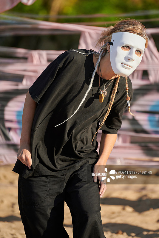 女人在舞台上戴着面具表演，动作流畅图片素材