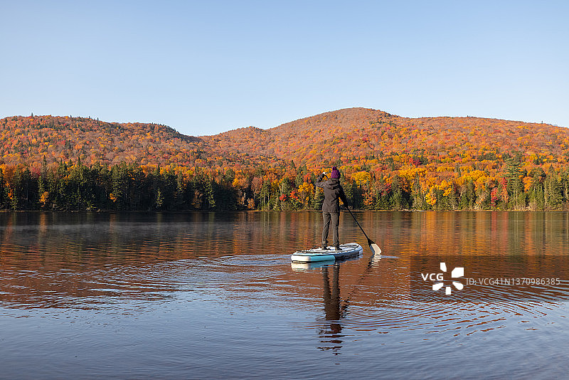 在加拿大魁北克省翠湖山国家公园秋季湖面上划桨的女人图片素材