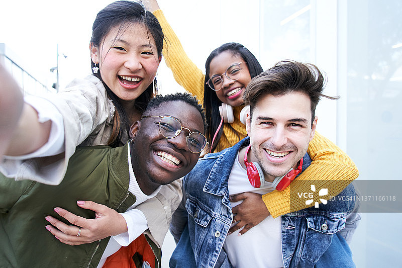 一群不同种族的学生朋友庆祝课程结束，一起自拍图片素材