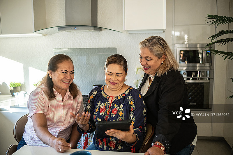 在家中使用平板电脑的拉丁裔女性朋友图片素材