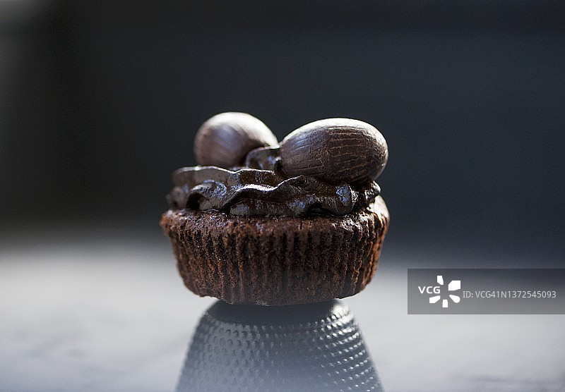 带有巧克力糖霜和巧克力复活节彩蛋的巧克力纸杯蛋糕（特写）图片素材