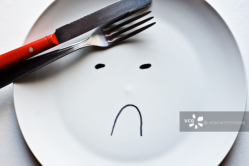 空盘子上画着悲伤的表情图片素材